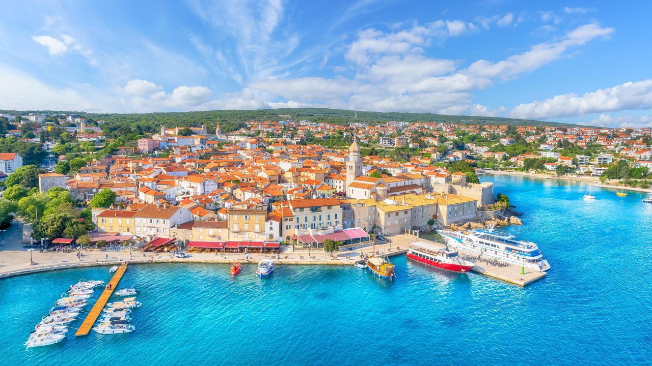 Aerial view of Krk Town old centre, marina, boats, and Adriatic waterfront