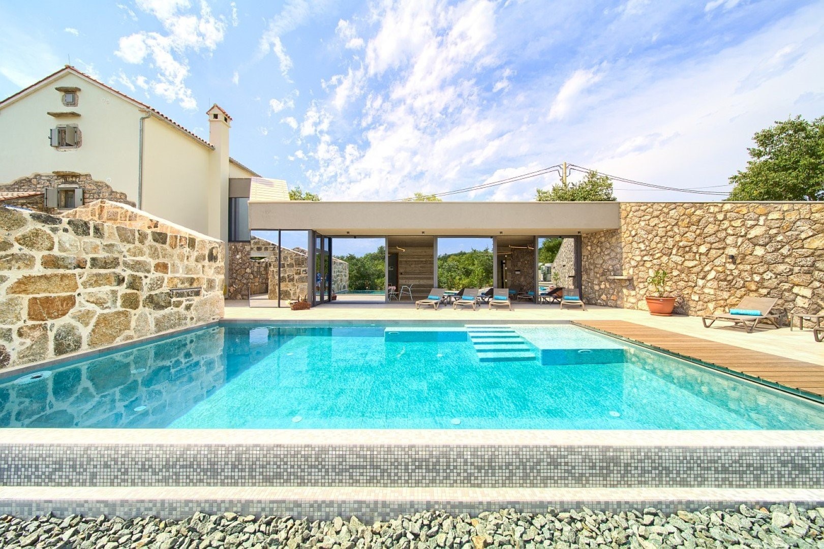 Private pool area at Jerini Estate in Bajčići near Krk in Croatia with sun loungers