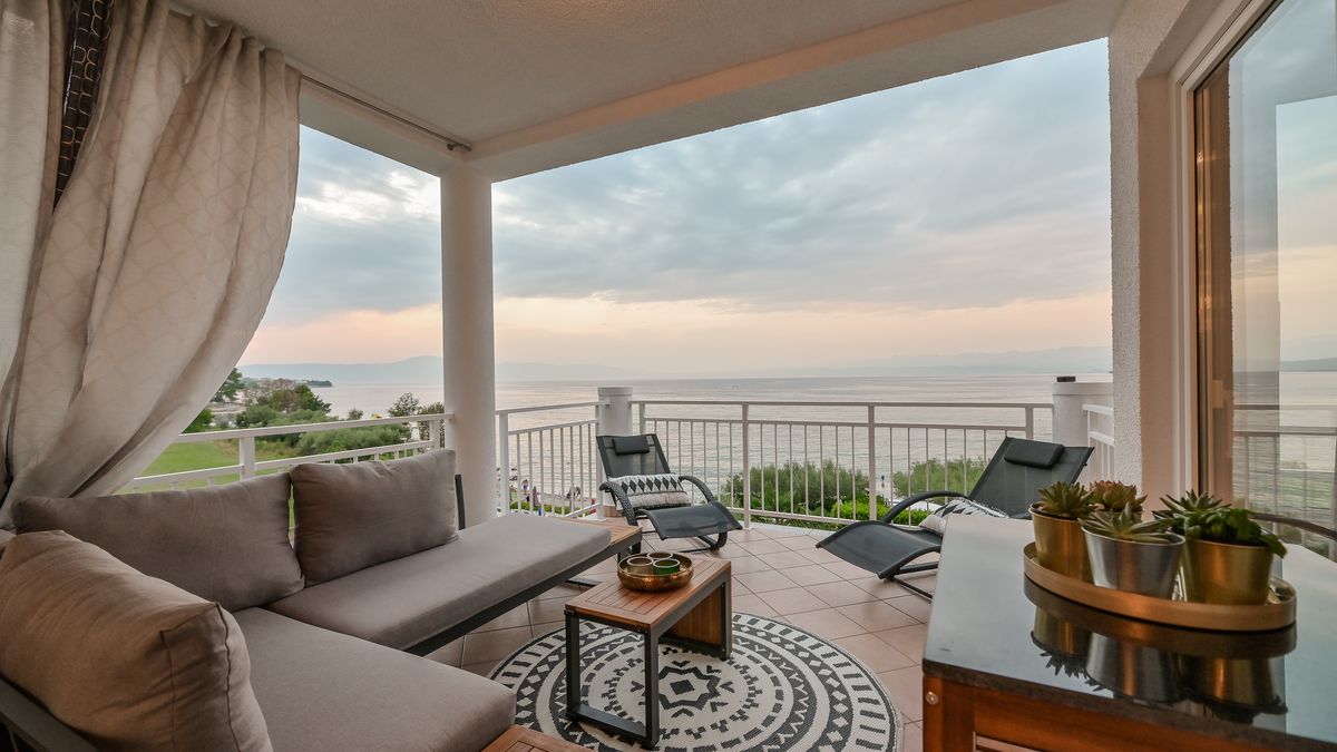 Covered terrace of Princess apartment with lounge seating and Adriatic sea view on Krk Island