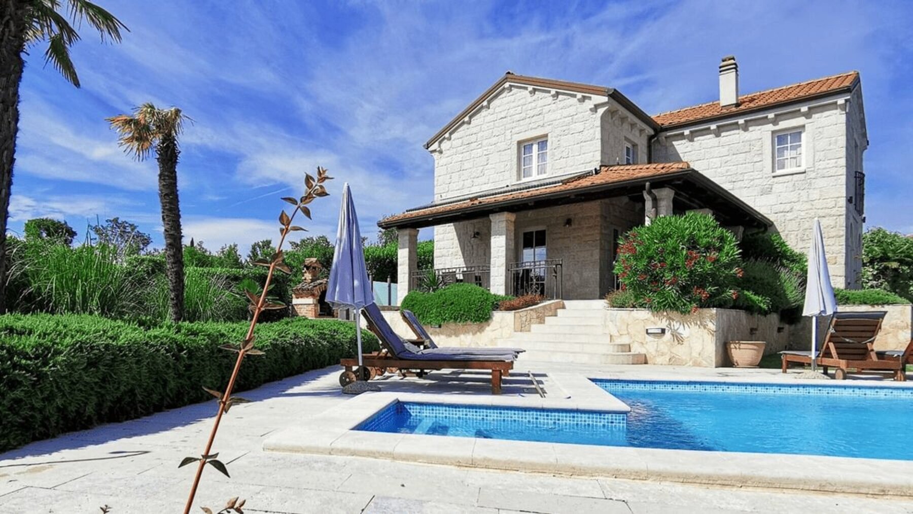 Mediterranean stone villa with private pool on Krk Island, surrounded by garden and sun terrace