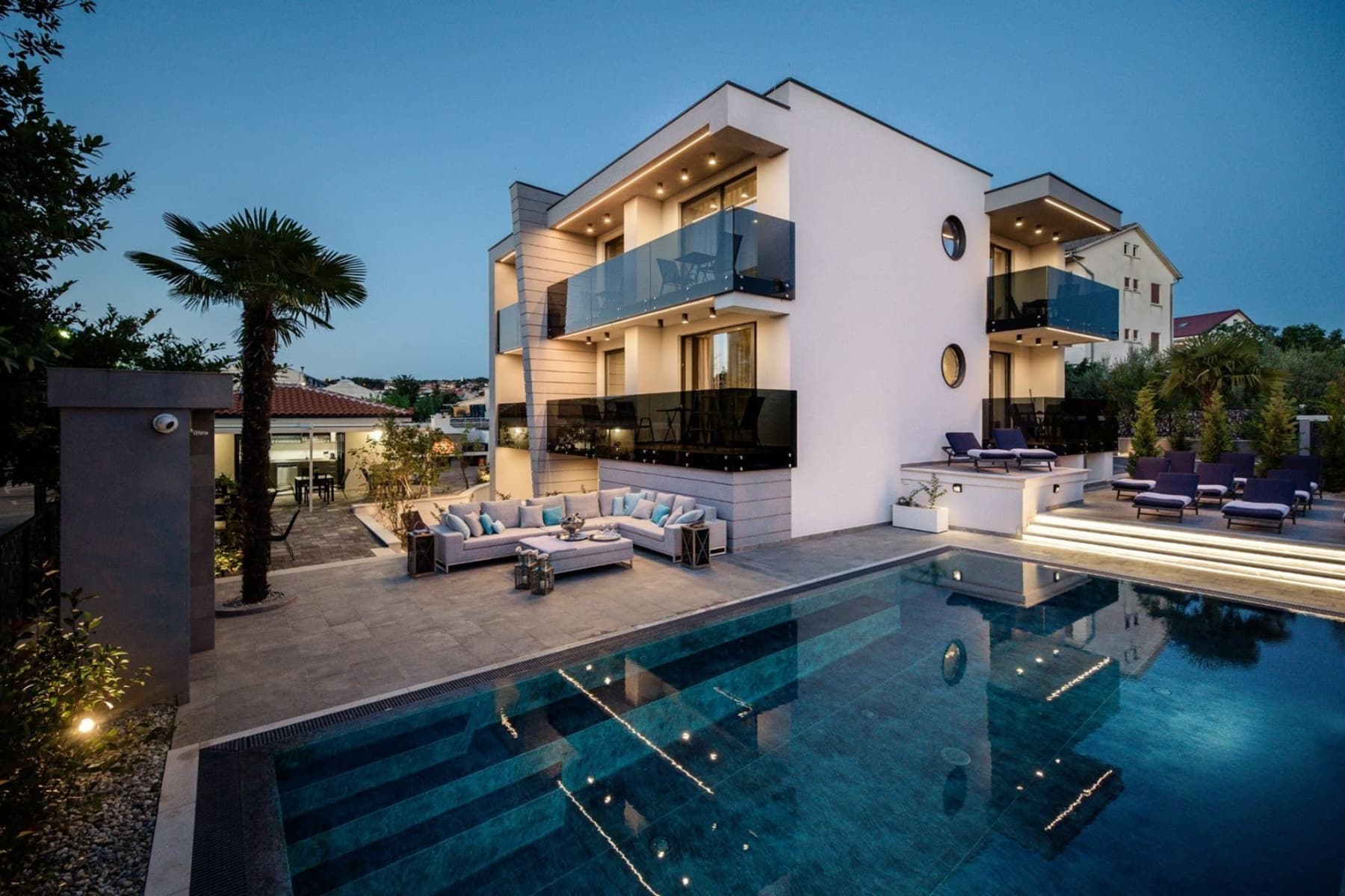 Luxury Villa Curiera in Malinska with pool, terrace seating and evening lighting