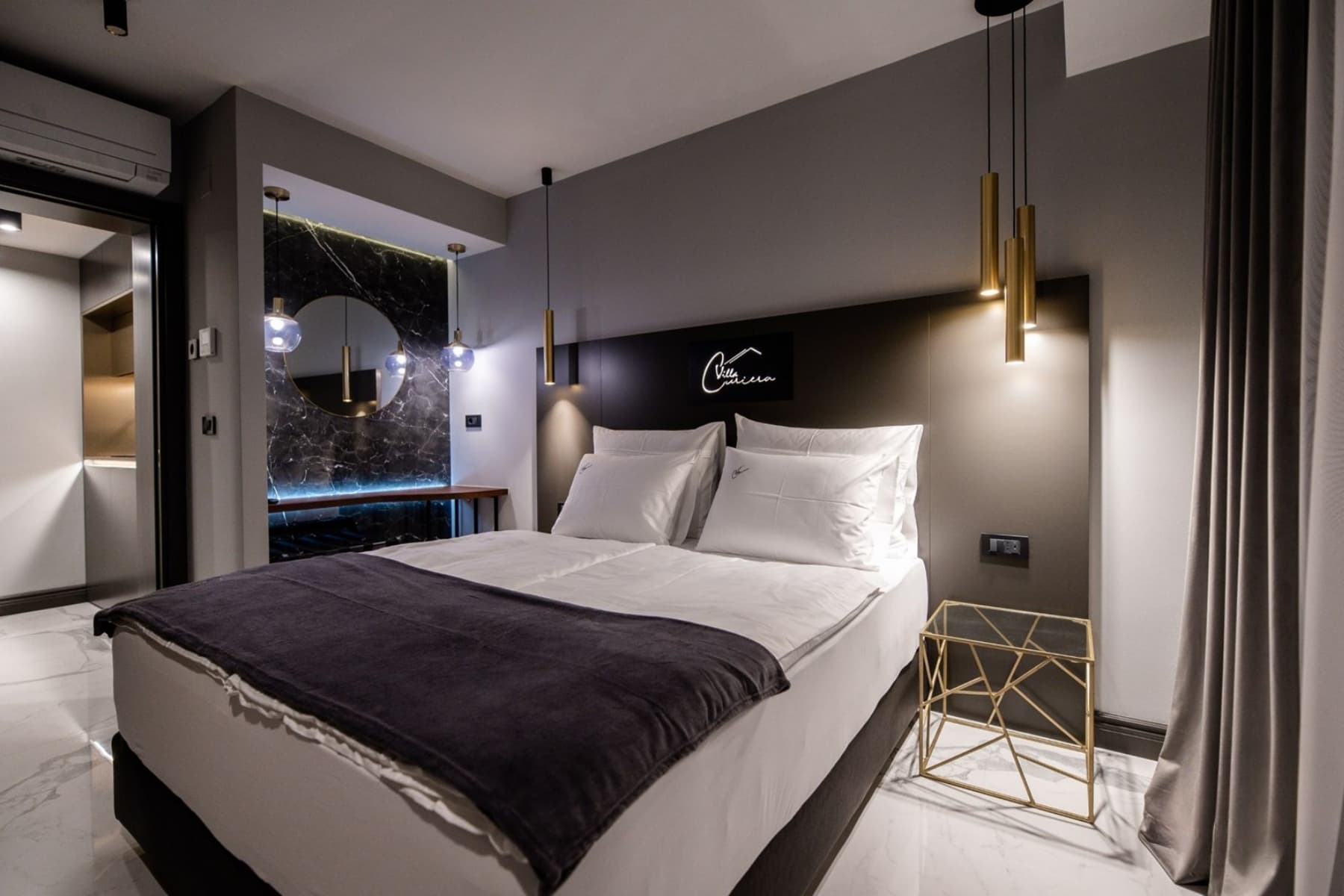 Modern Villa Curiera bedroom with double bed, ambient lighting and minimalist interior design