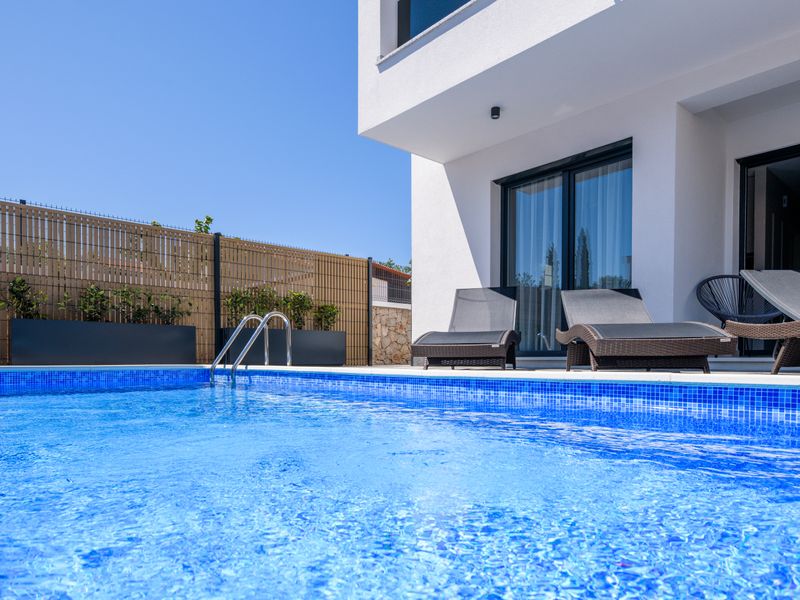Stylish Villa Metra Maris in Malinska with a private pool and a modern outdoor relaxation area