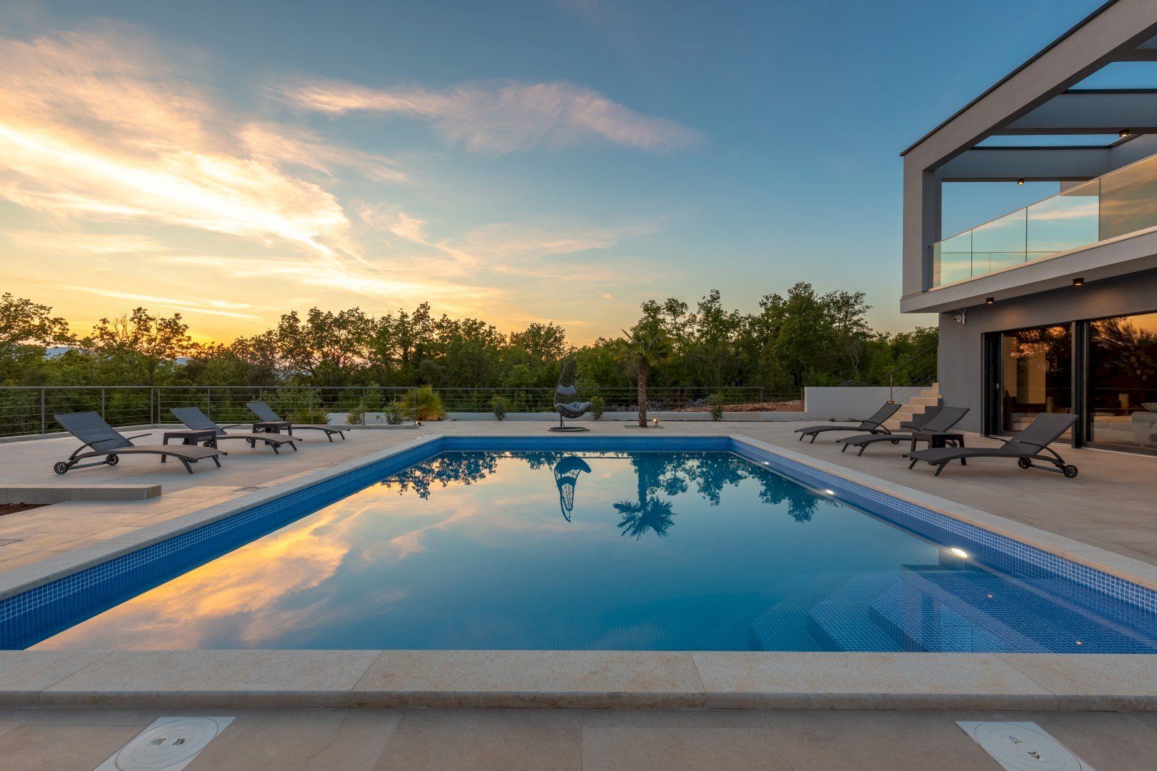 Villa Quadra on Krk Island with outdoor pool, terrace, and modern architecture at sunset